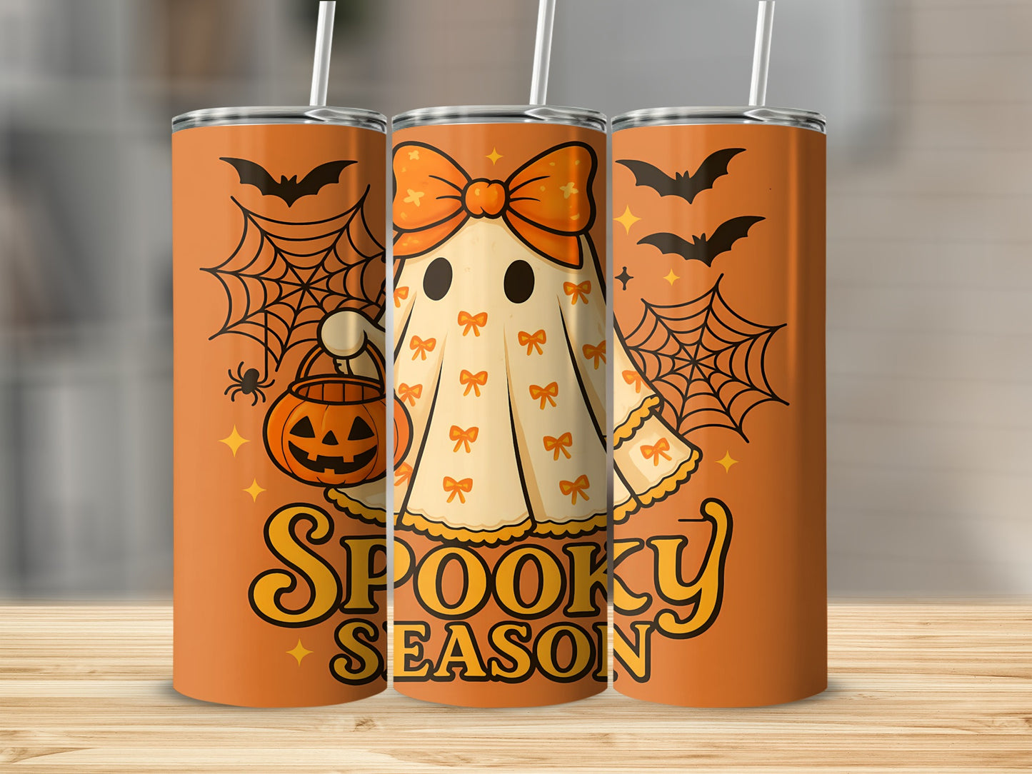 Orange tumbler with a cartoon ghost, jack-o'-lantern, bats, and "Spooky Season" text.