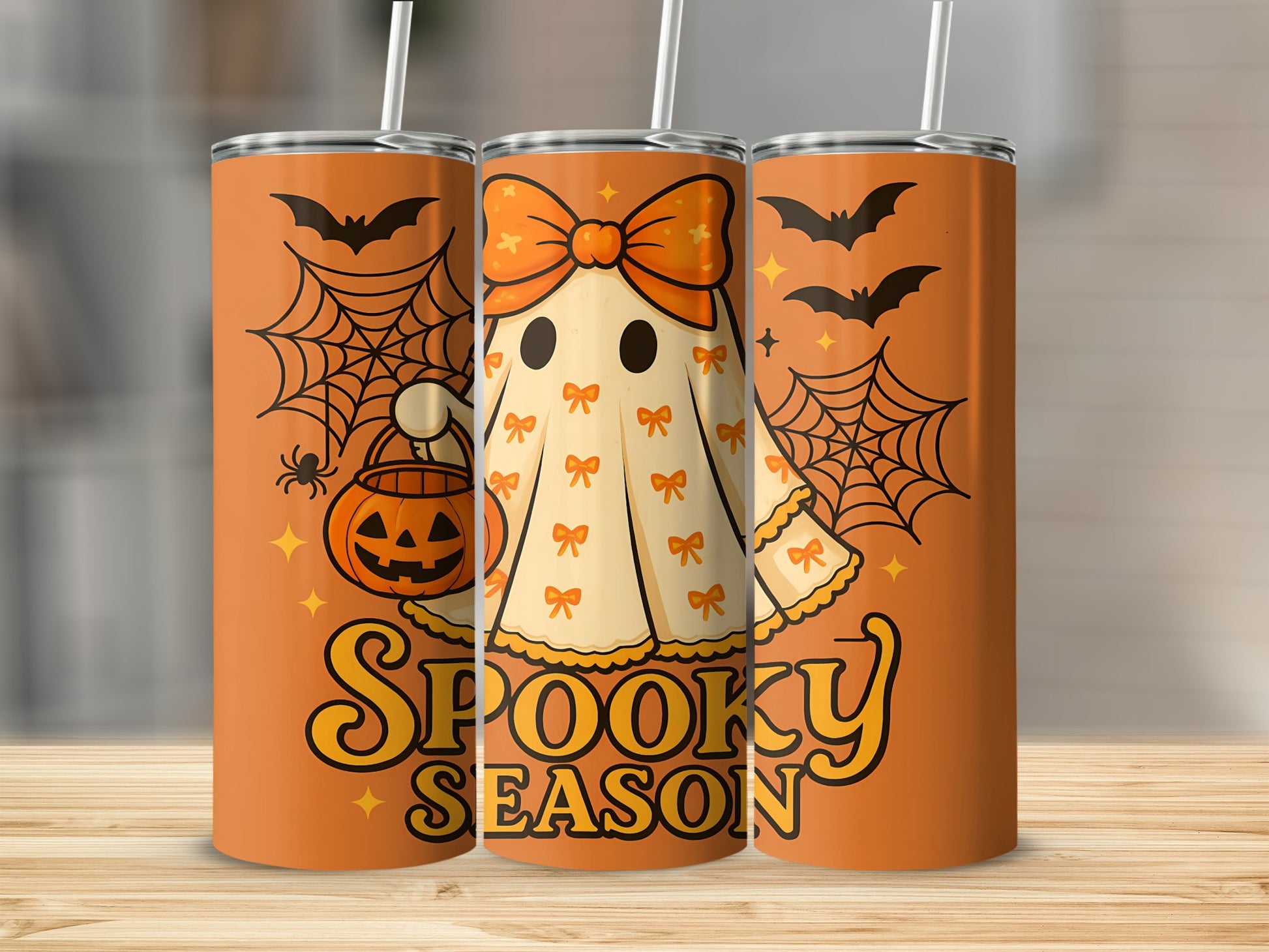 Orange tumbler with a cartoon ghost, jack-o'-lantern, bats, and "Spooky Season" text.