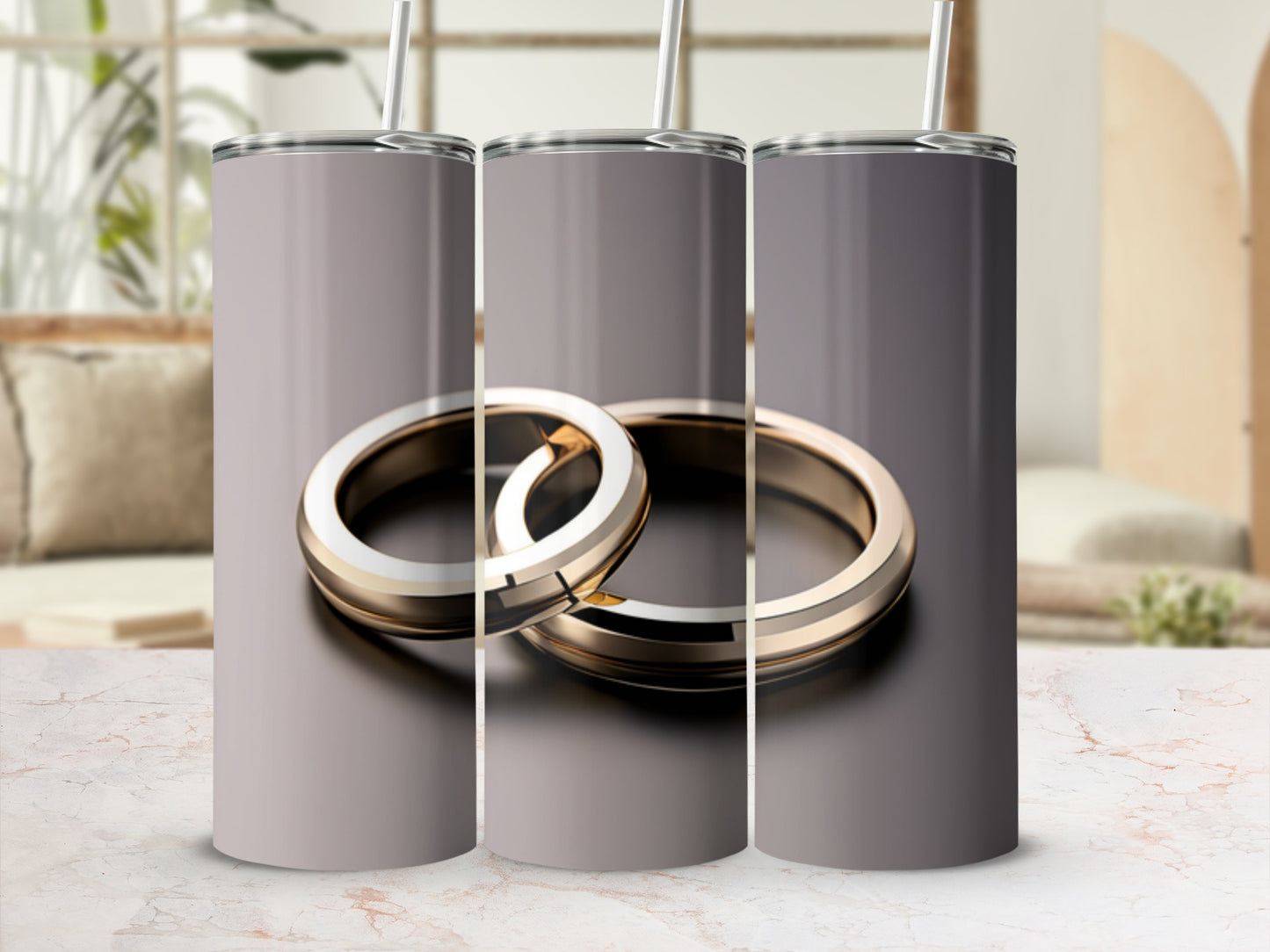 Three silver and gold wedding rings on a textured surface.