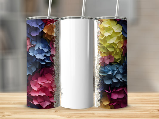 White tumbler with colorful floral pattern and glitter trim.