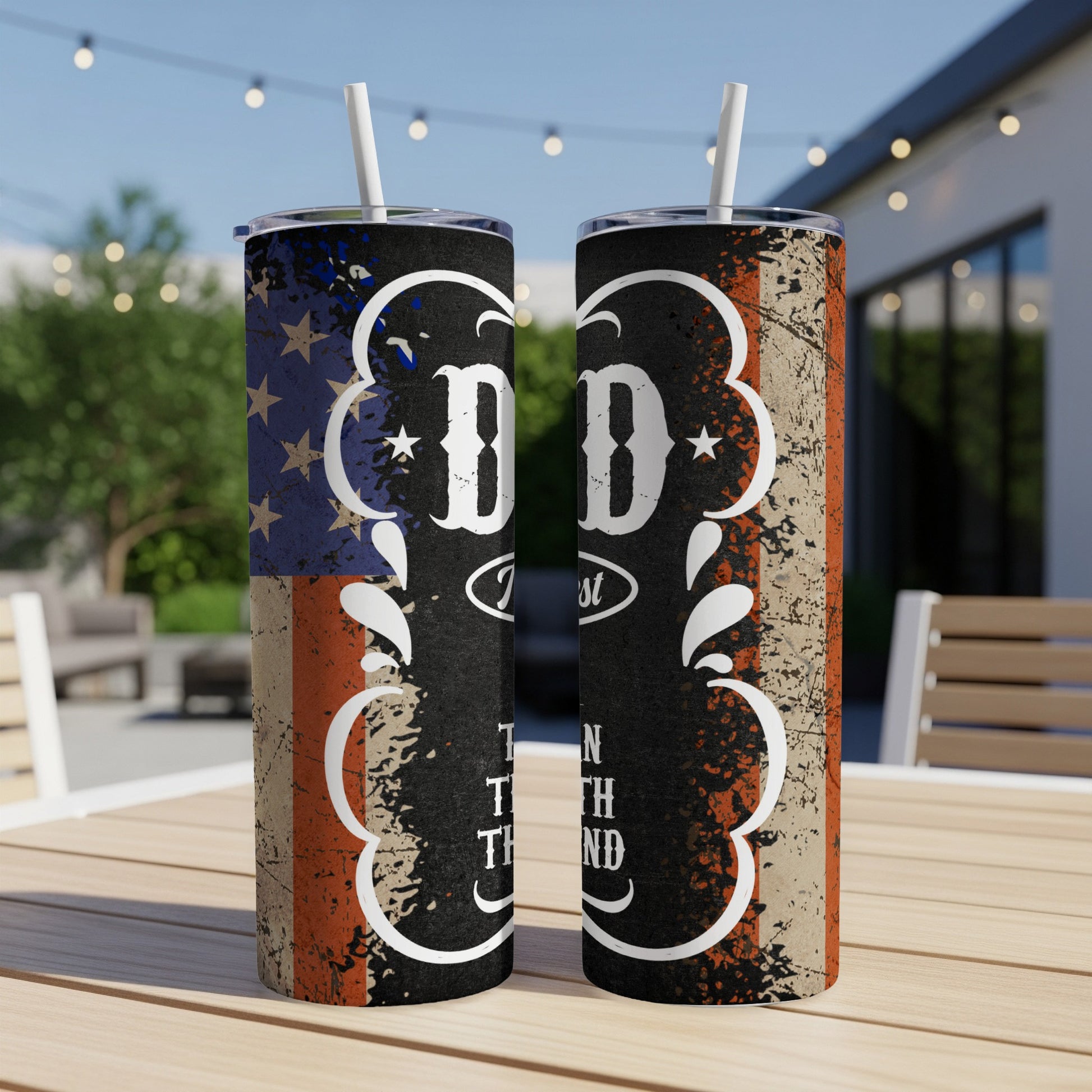 Two tumblers with American flag design and text "DAD Forever" on a wooden table.