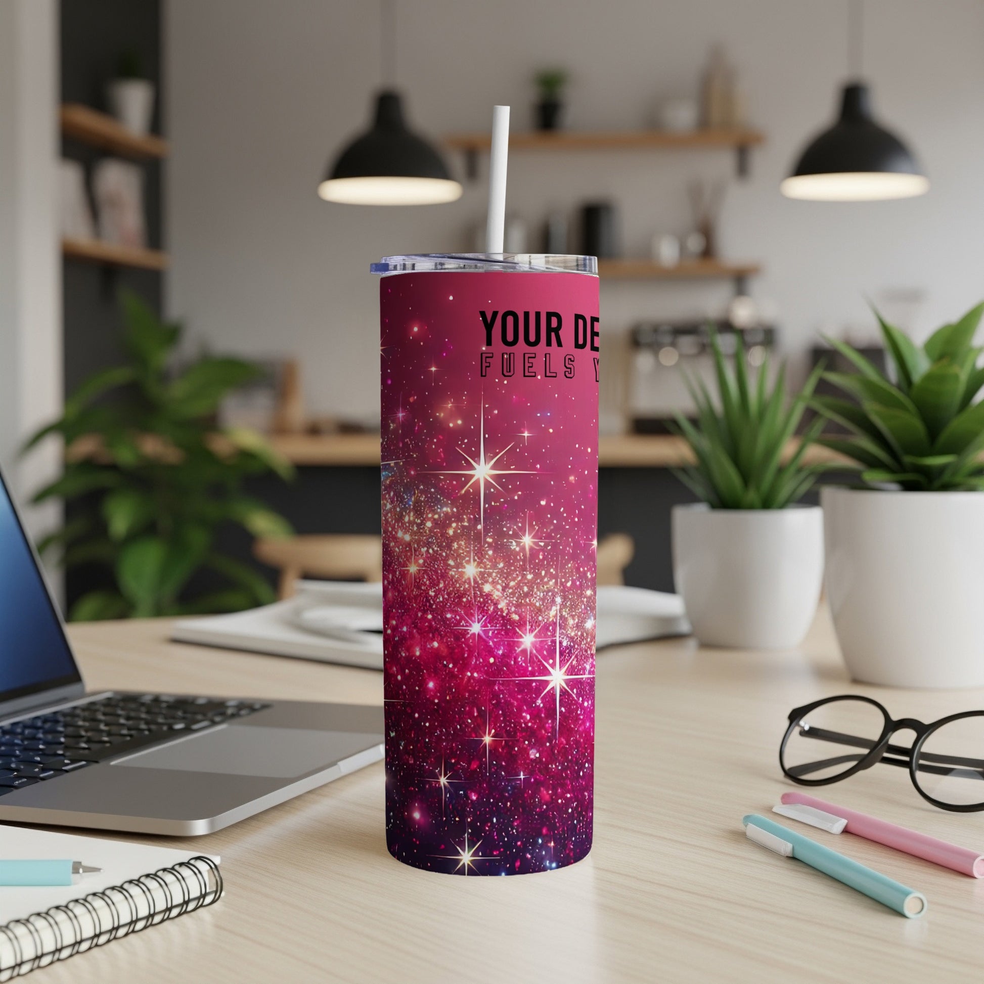 Sparkling pink glitter tumbler with "YOUR DE FUELS Y" text on a desk.