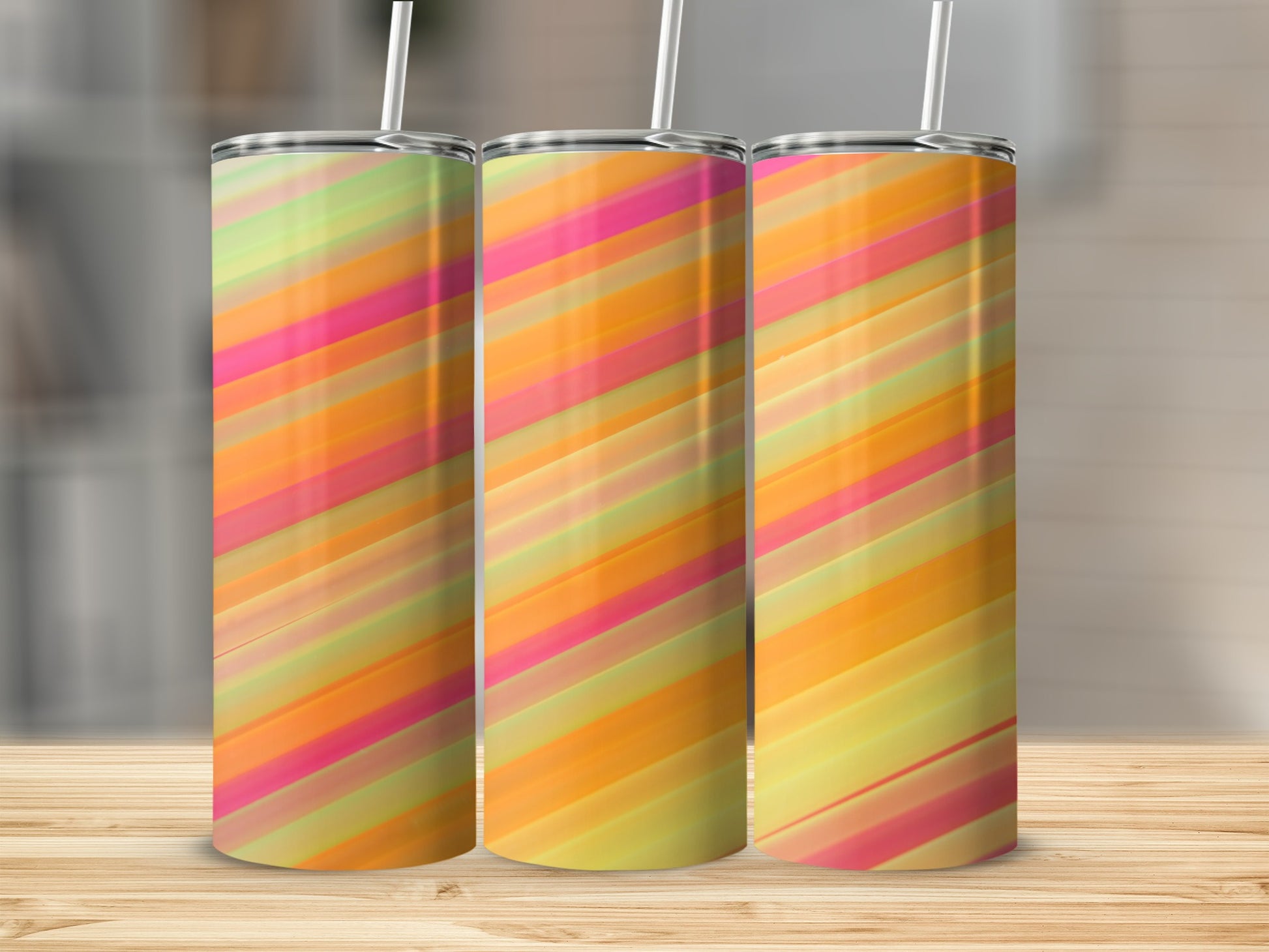 Three tumblers with diagonal stripes of pink, orange, yellow, and green.