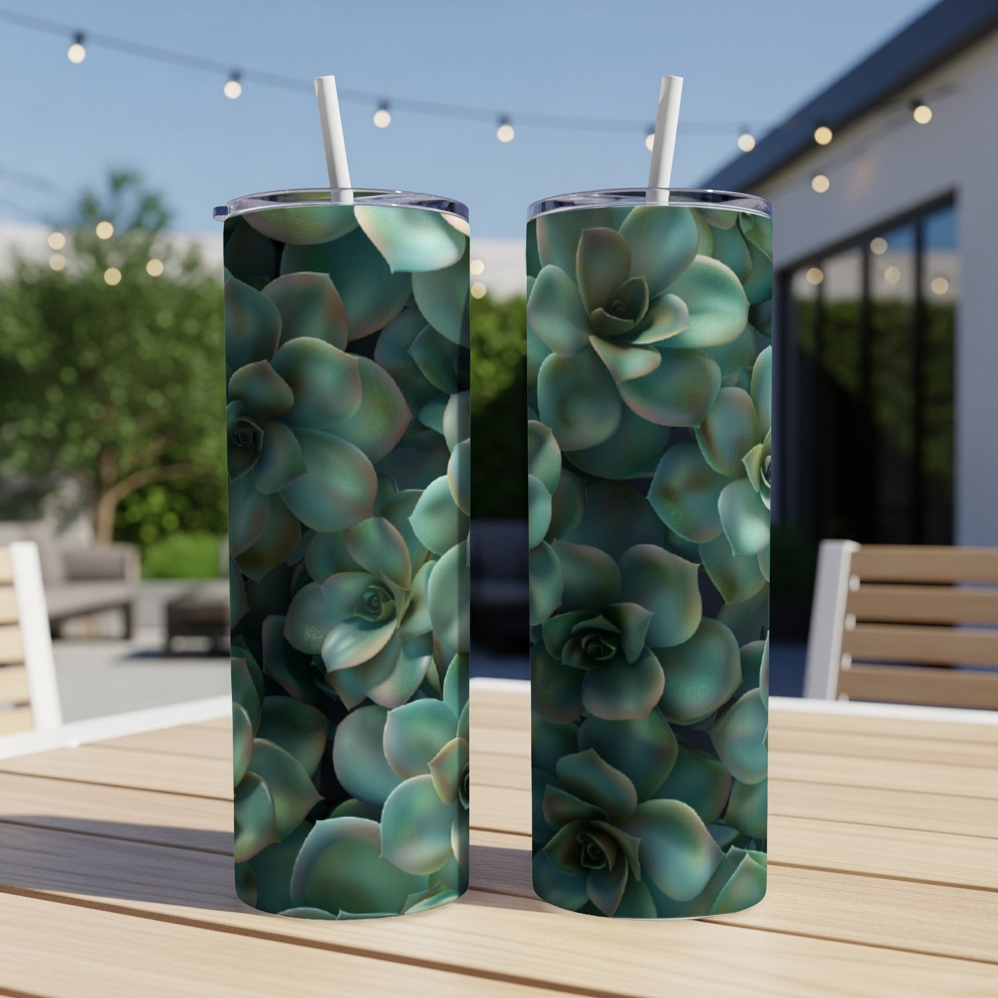 Two tumblers with a close-up succulent plant pattern on a patio table.