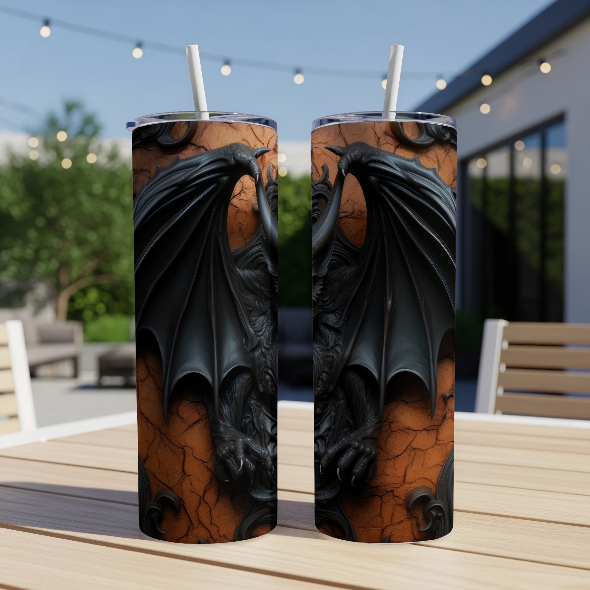 Two tumblers with black dragon wings and claws design on a cracked orange background.