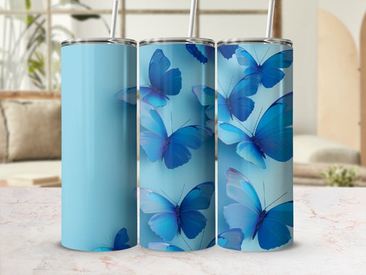 Three light blue tumblers with blue butterfly designs.