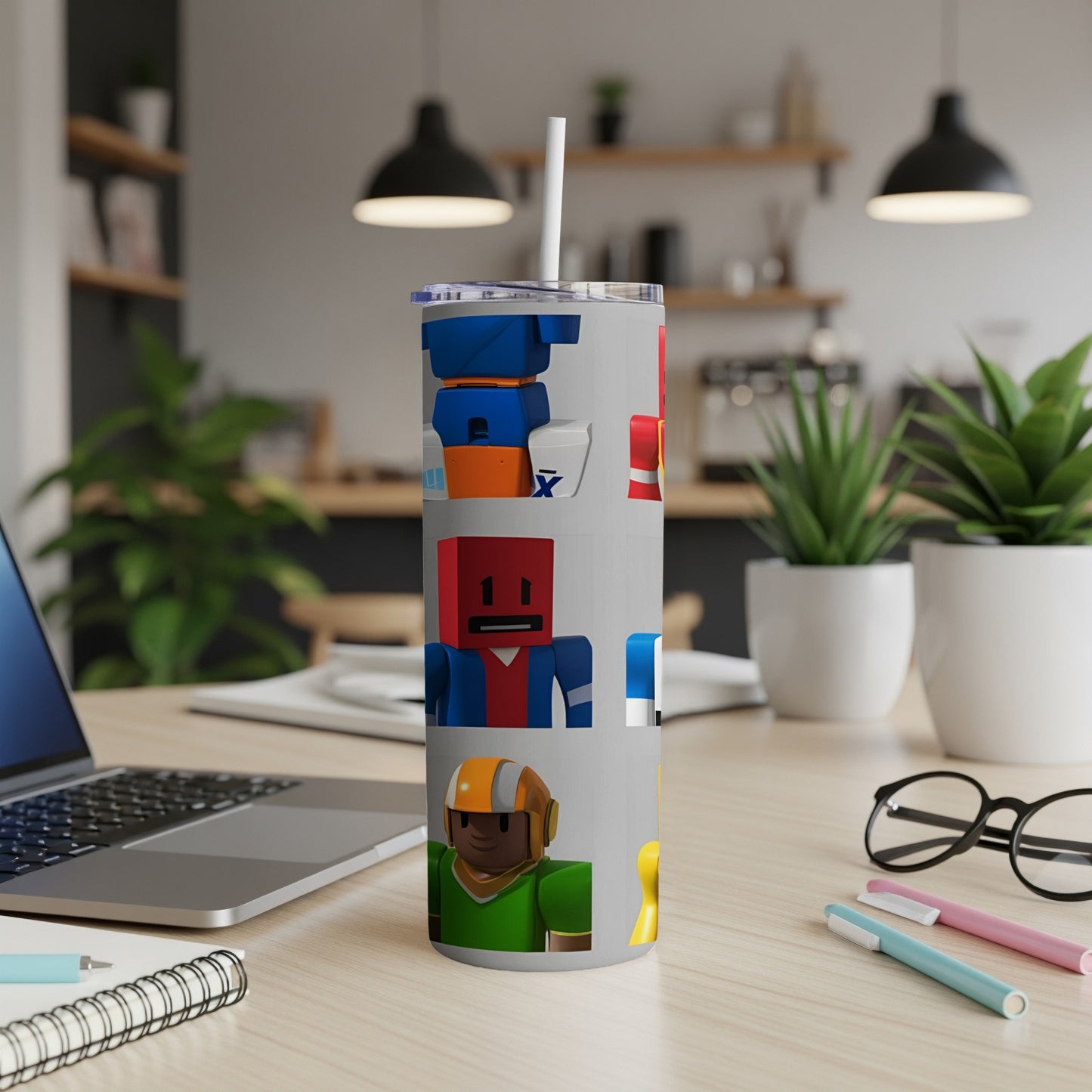 Tumbler with colorful blocky robot characters on a light gray background.