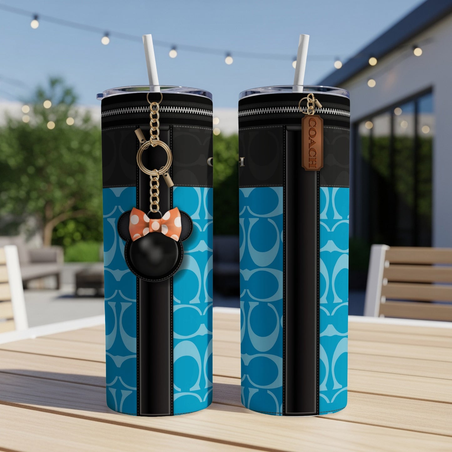 Two tumblers with blue Coach pattern and Minnie Mouse charm.