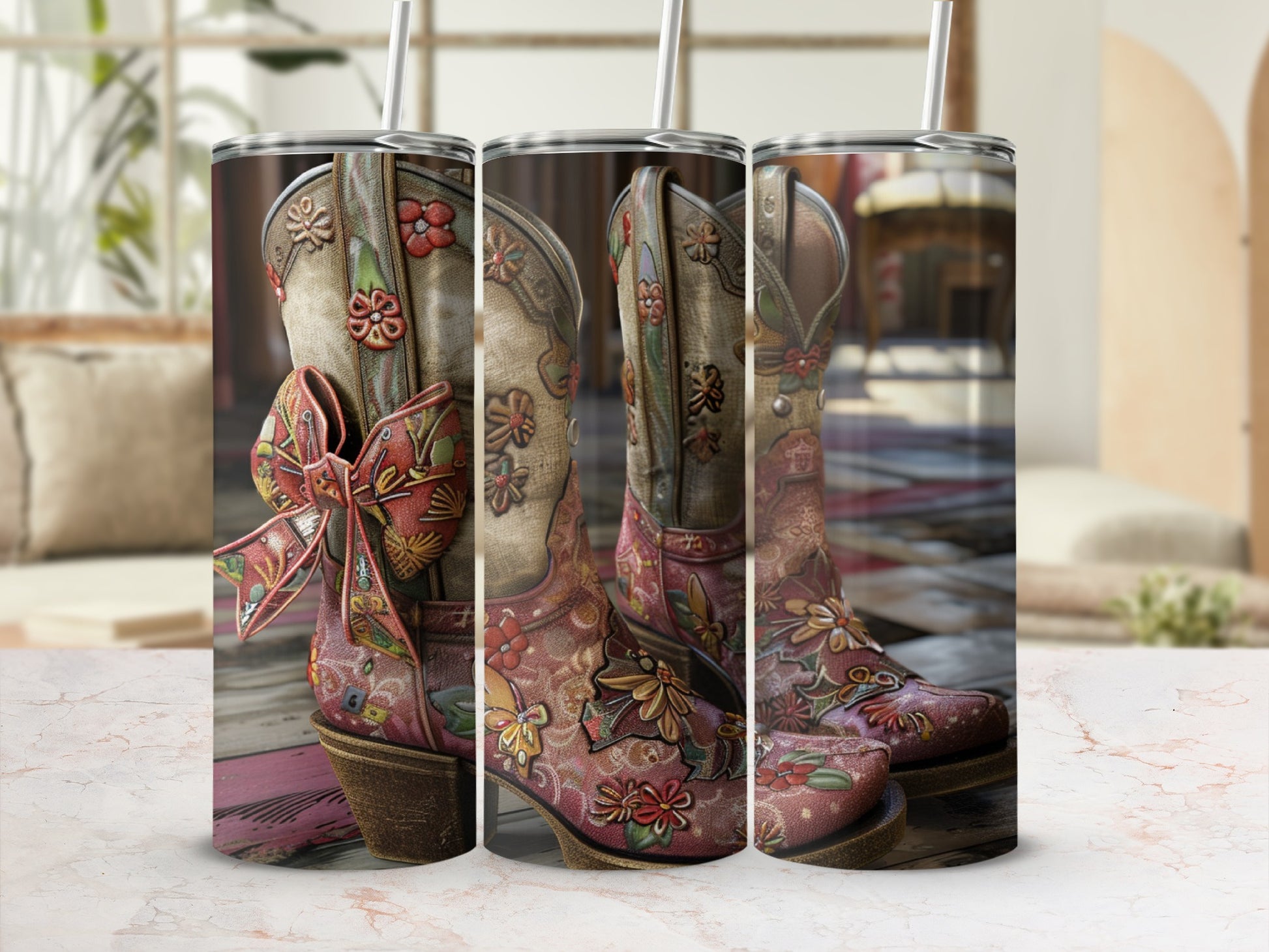 Cowboy boots with floral designs and a red bow, on a wooden surface.