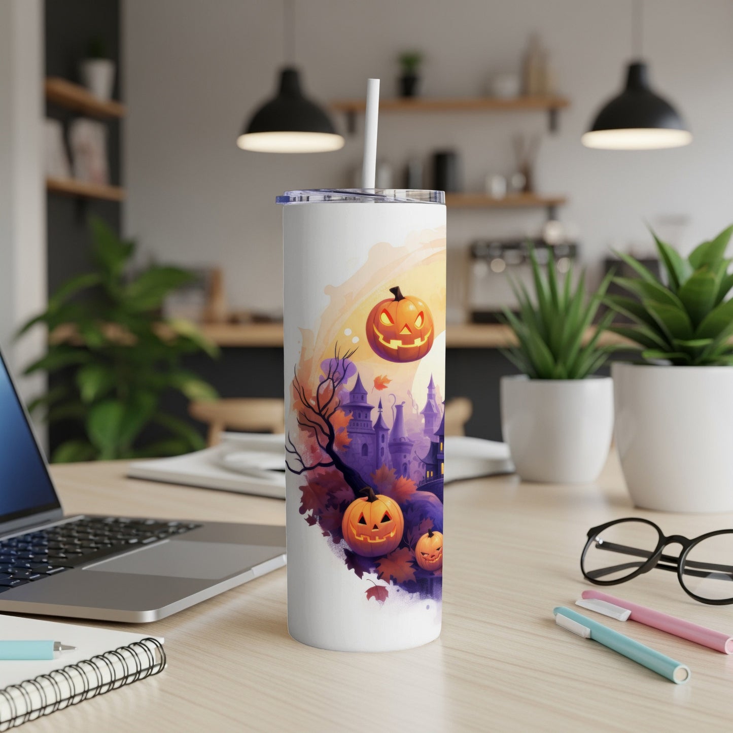 White tumbler with Halloween castle, pumpkins, and falling leaves design.