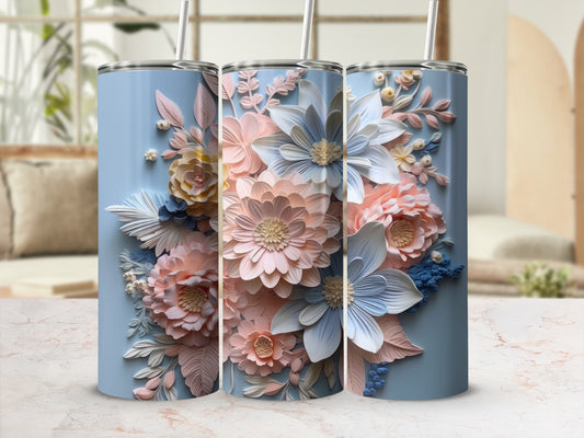 Three light blue tumblers with floral designs, one straw each.