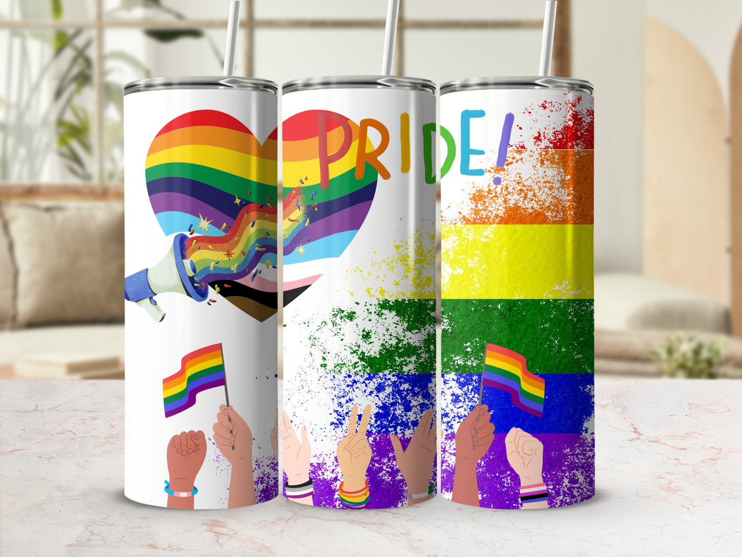 Pride themed tumblers with rainbow heart, flag, and paint splatter designs.