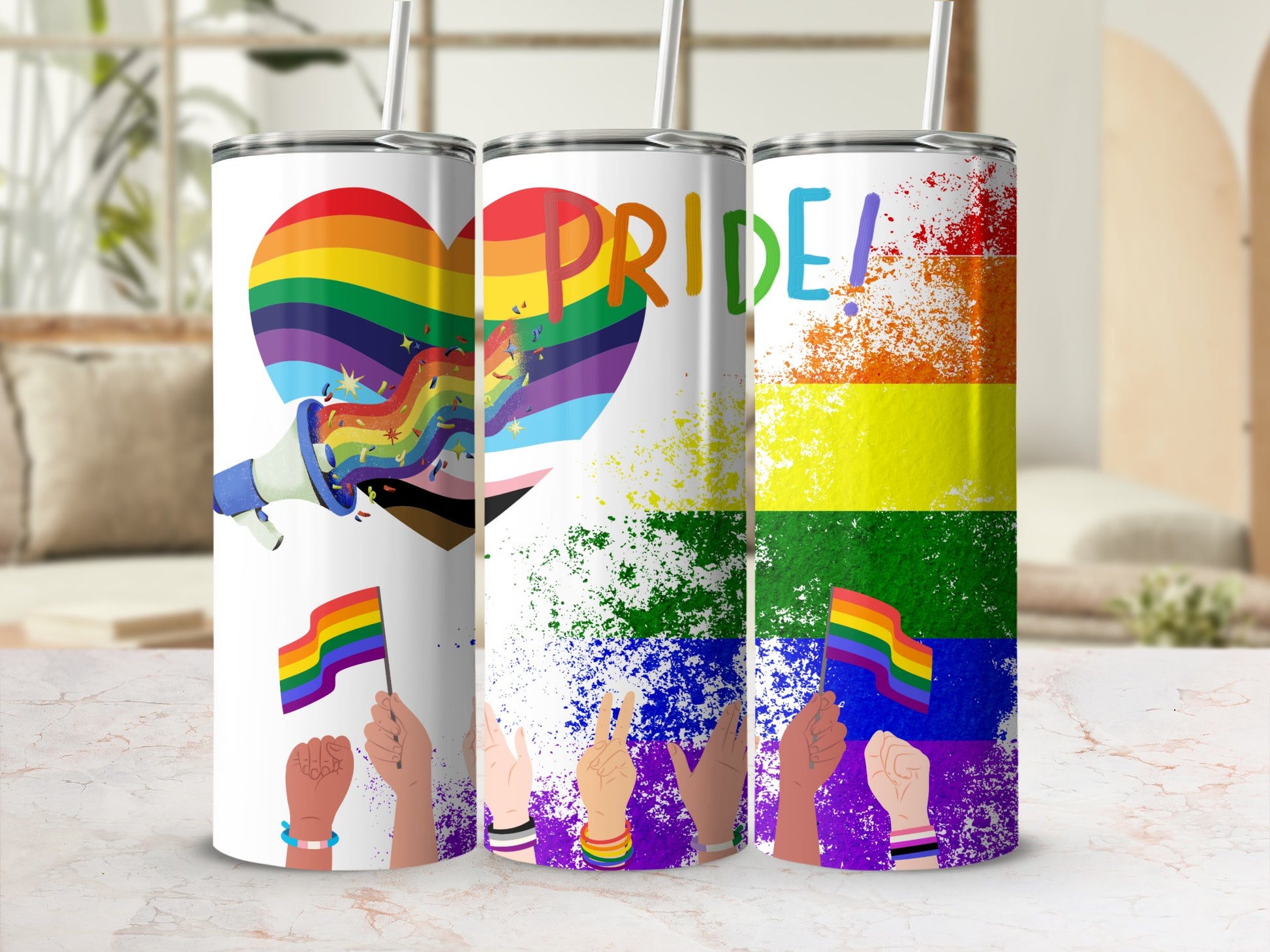 Pride themed tumblers with rainbow heart, flag, and paint splatter designs.
