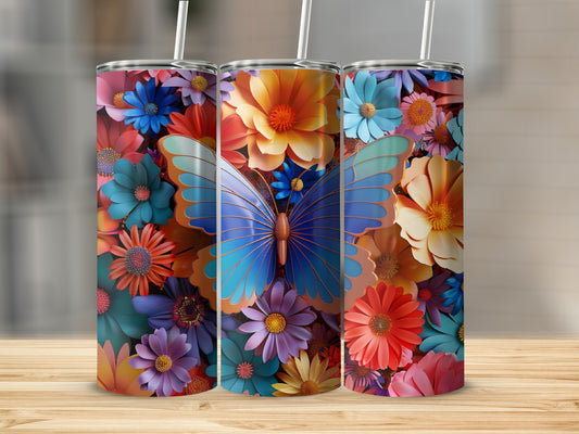 Three colorful tumblers with floral and butterfly designs on a wooden surface.