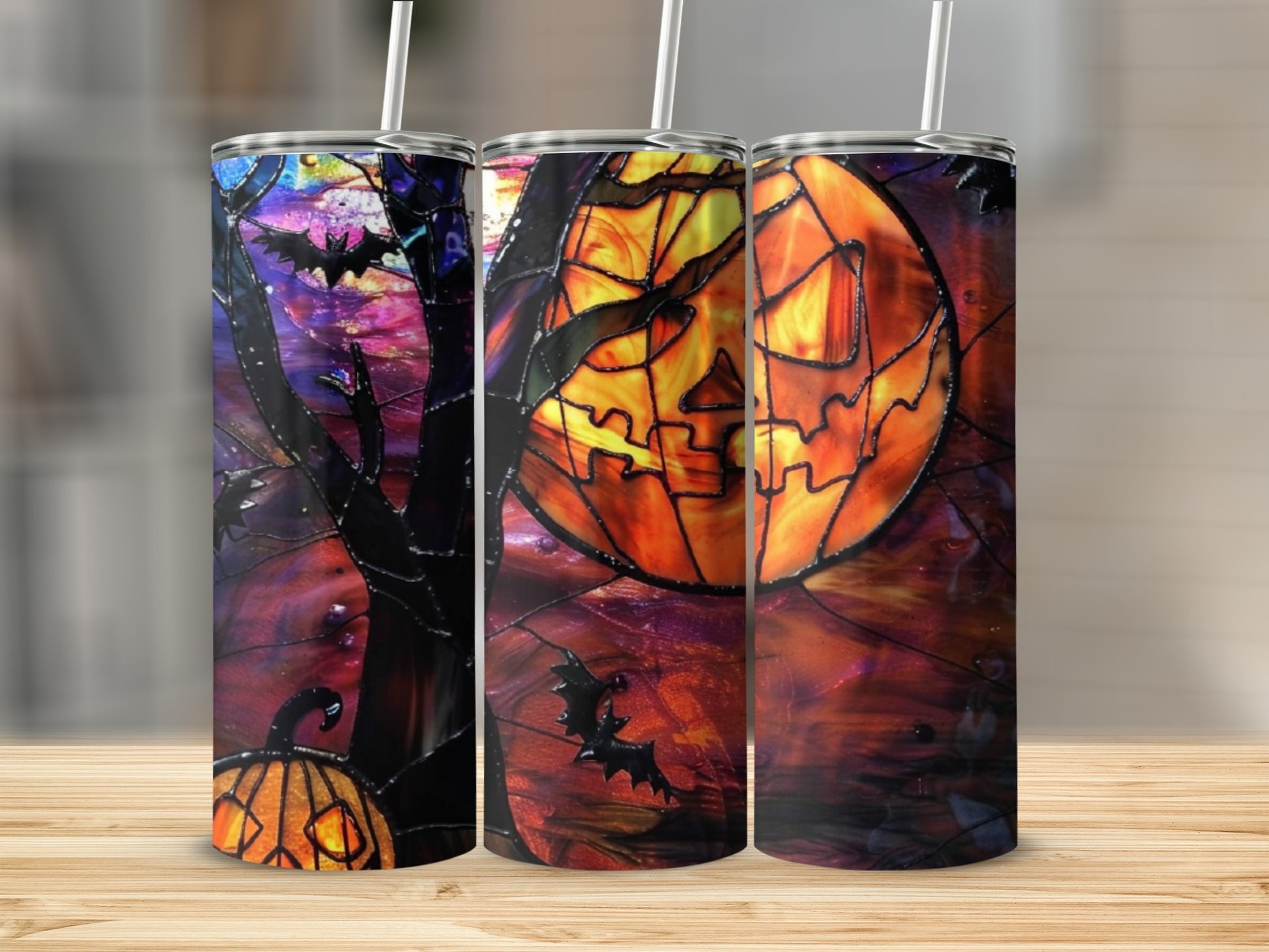 Halloween themed tumblers with pumpkin, bat, and jack-o'-lantern designs.