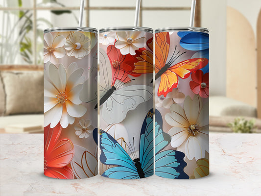 Three tall tumblers with floral and butterfly designs, standing on a marble surface.