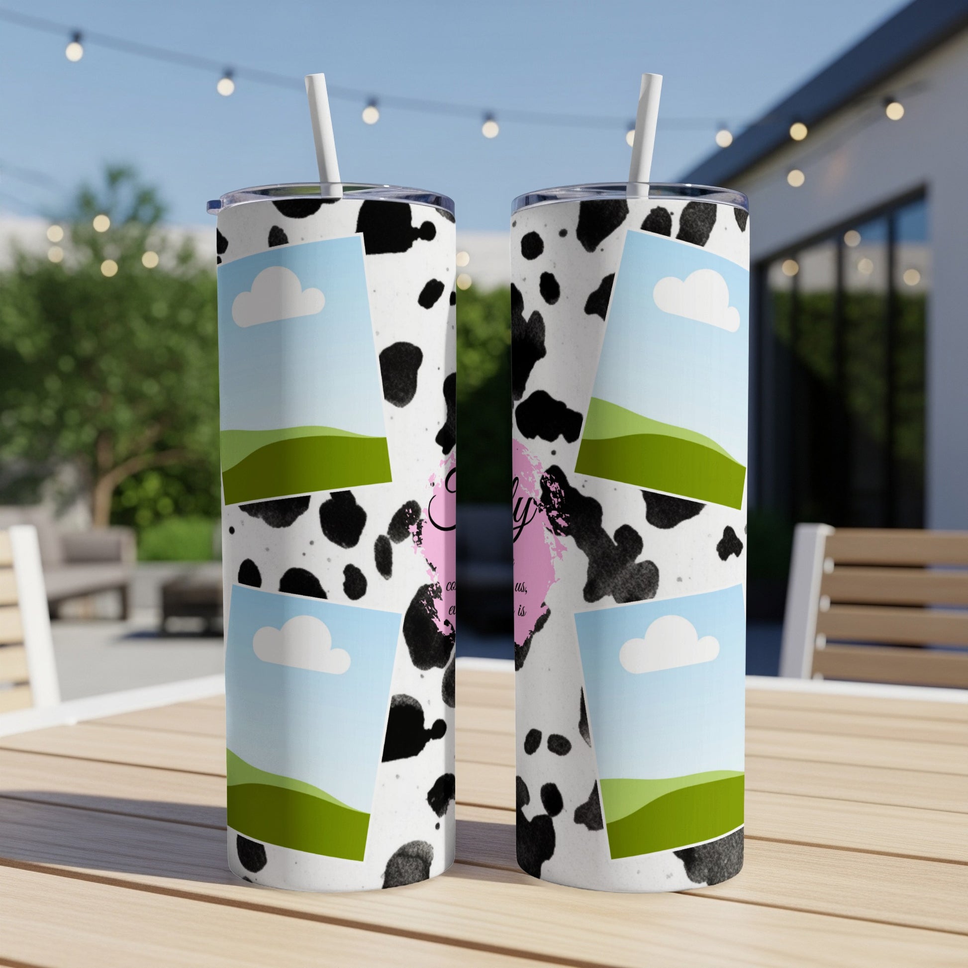Cow print tumblers with landscape and cloud photo frames and pink text.