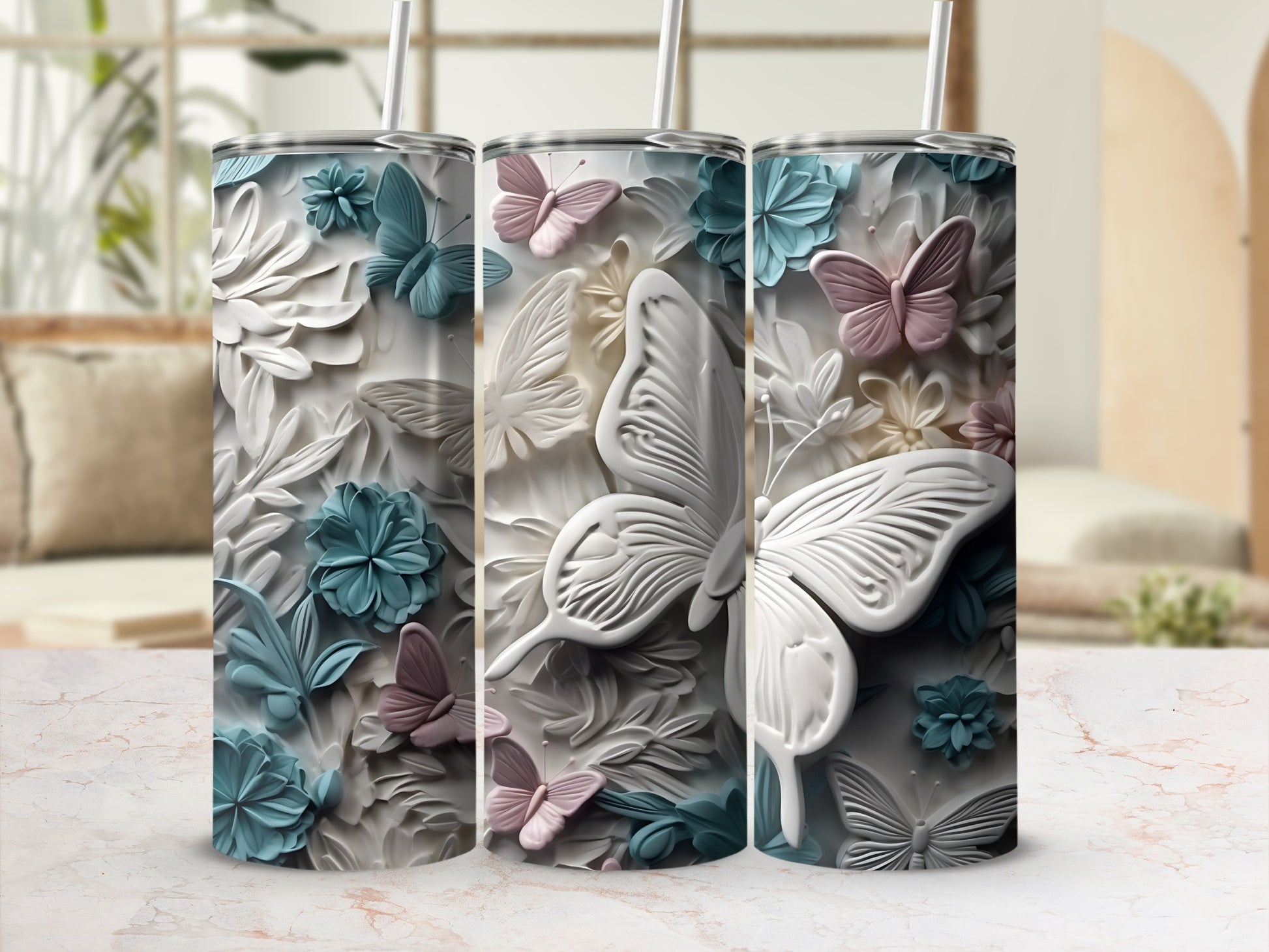 Three tumblers with raised floral and butterfly designs in pastel colors.