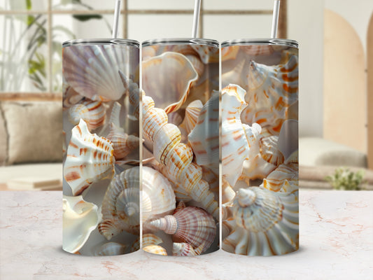 Triptych of tall tumblers featuring seashell patterns against a blurred beach background.