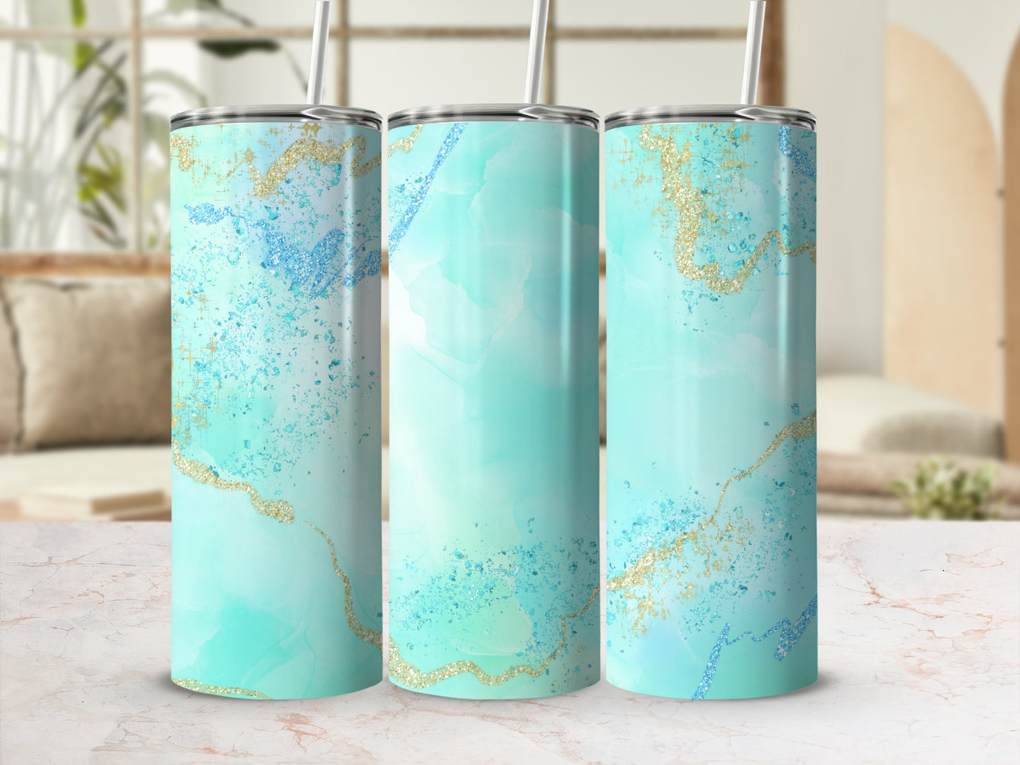 Three teal and gold marble pattern tumblers with straws.