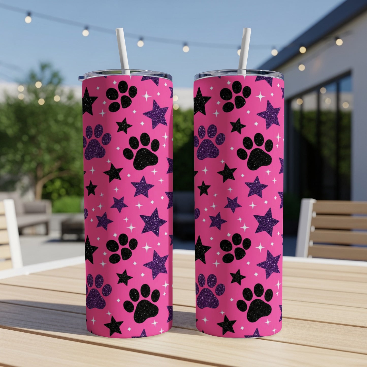 Pink tumbler with paw print and star pattern.