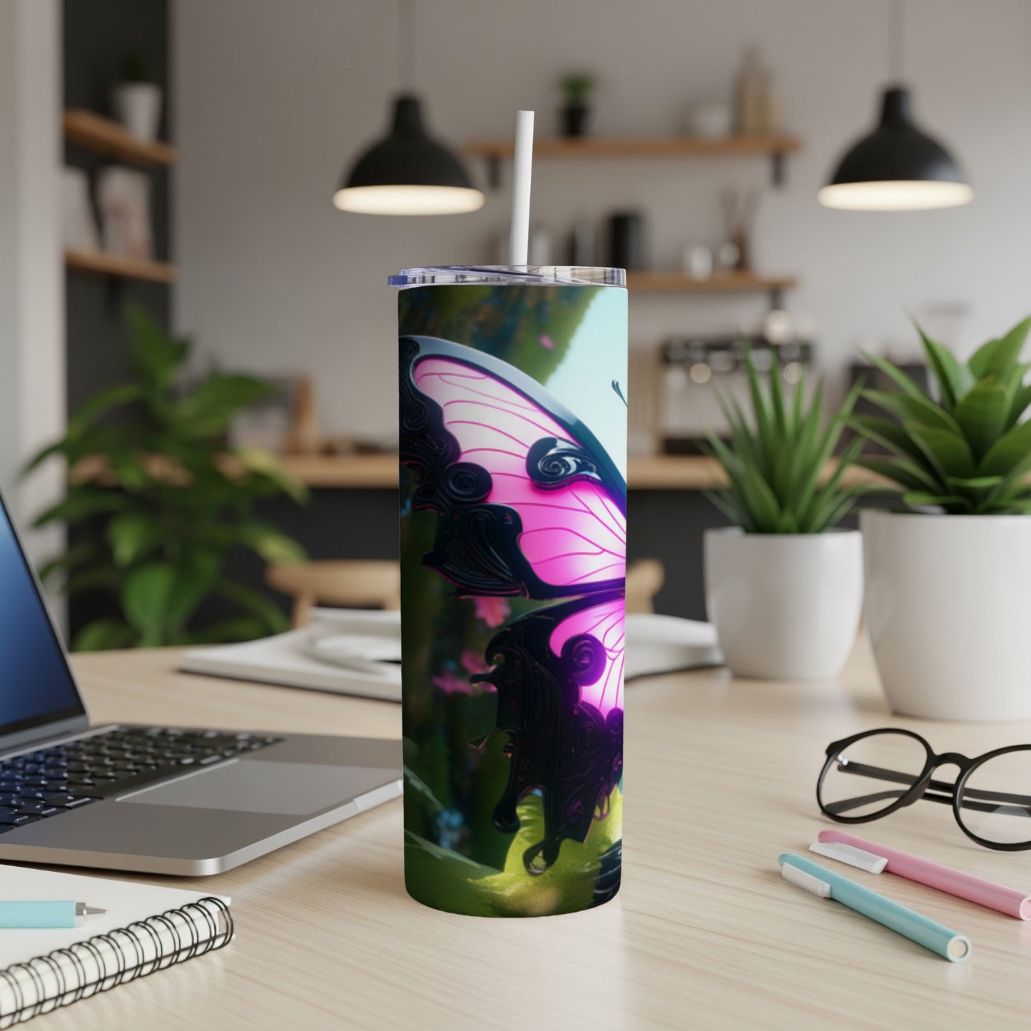 Pink butterfly tumbler with a white straw on a desk.