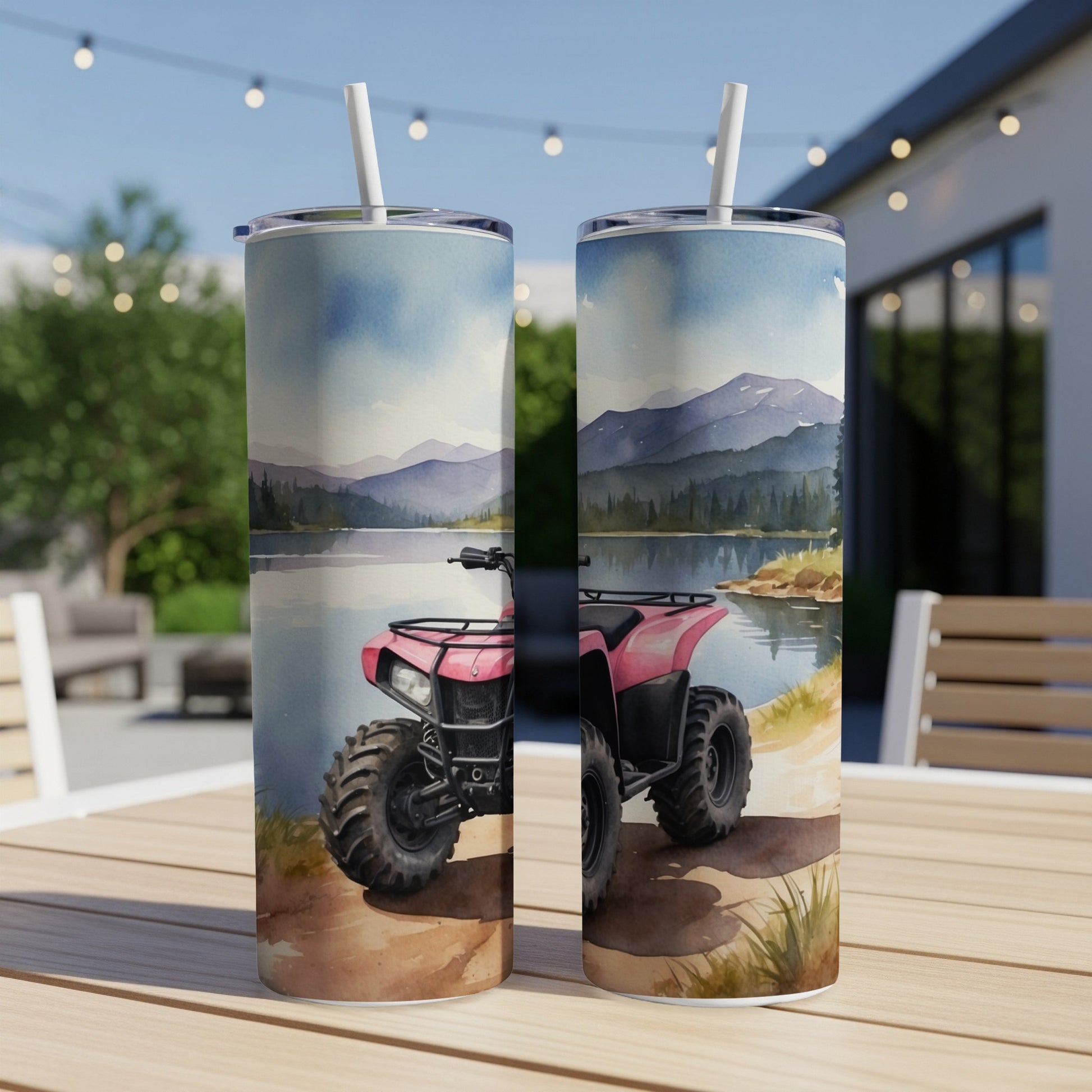Pink ATV on a lakeside trail, with mountains and trees in the background.