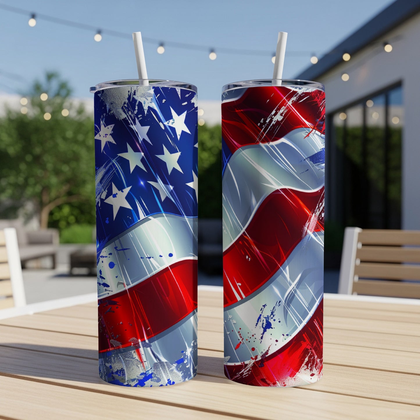 Two American flag themed tumblers on a wooden table outdoors.