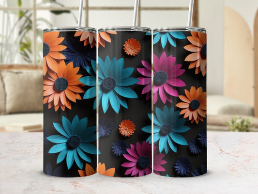 Three tumblers with colorful floral designs on a black background.