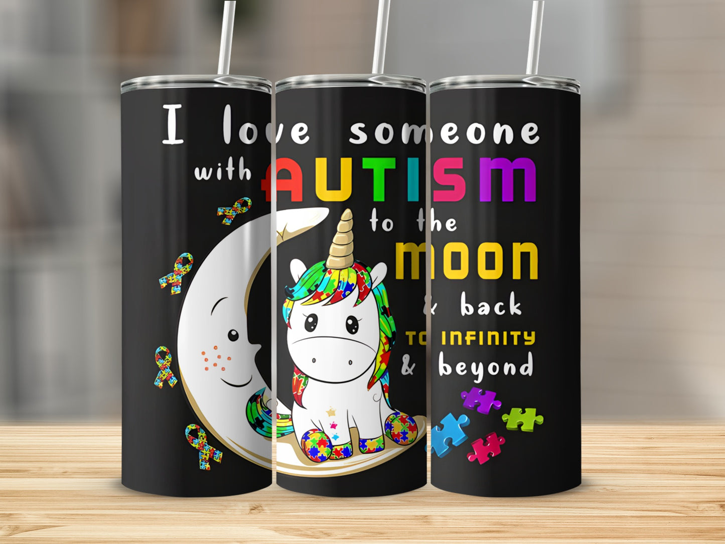 Tumbler with colorful unicorn and autism awareness ribbons and puzzle pieces.