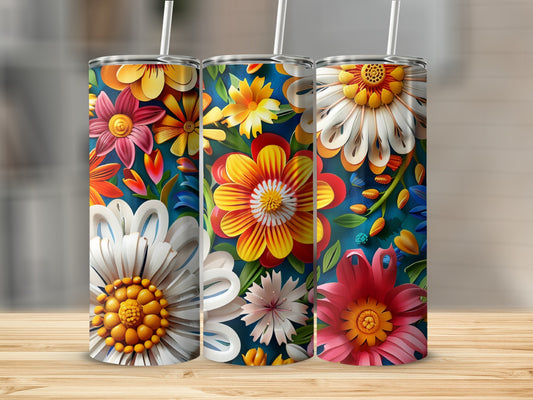 Three colorful floral tumblers with straws on a wooden surface.