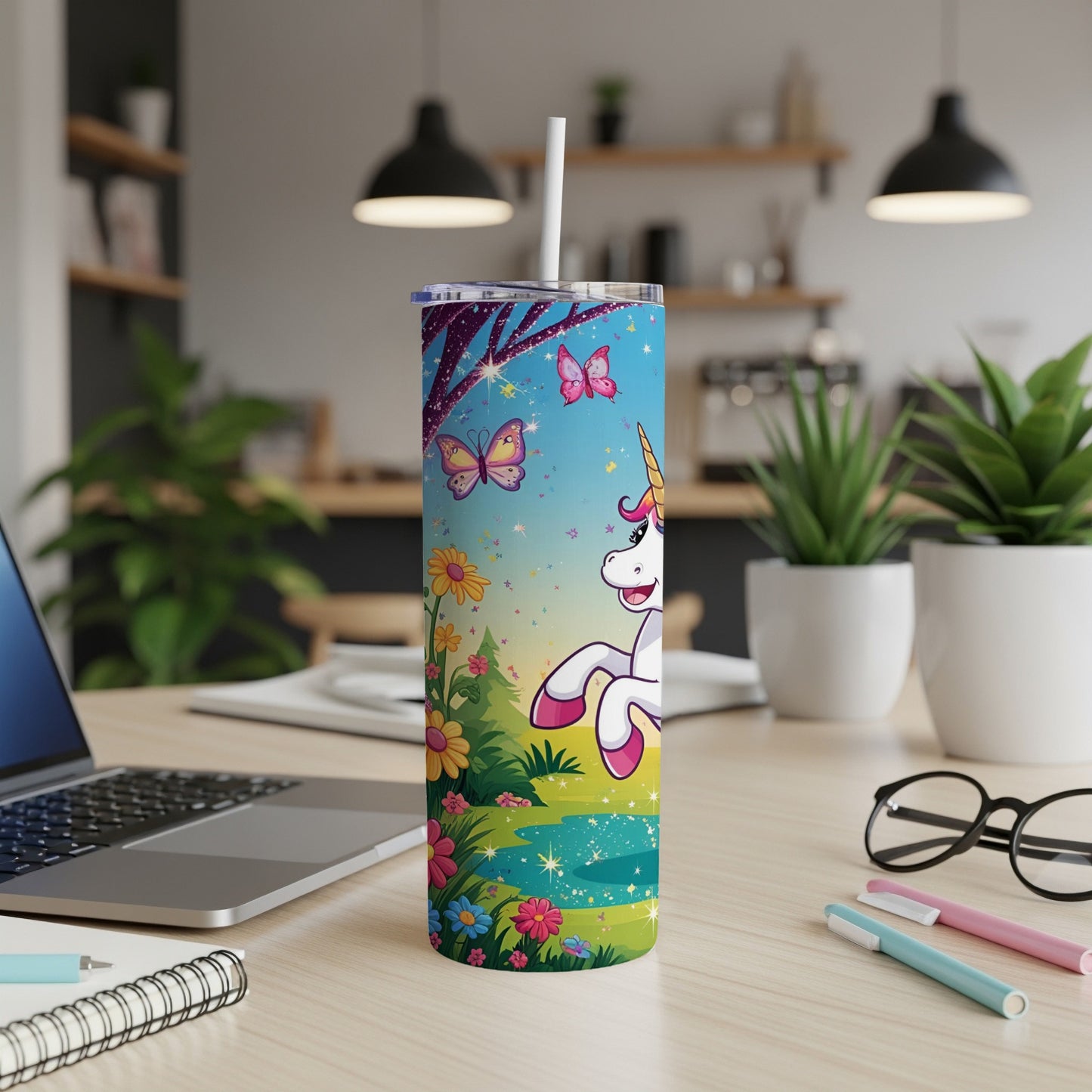 Unicorn and butterflies on a sparkly blue tumbler with a straw.