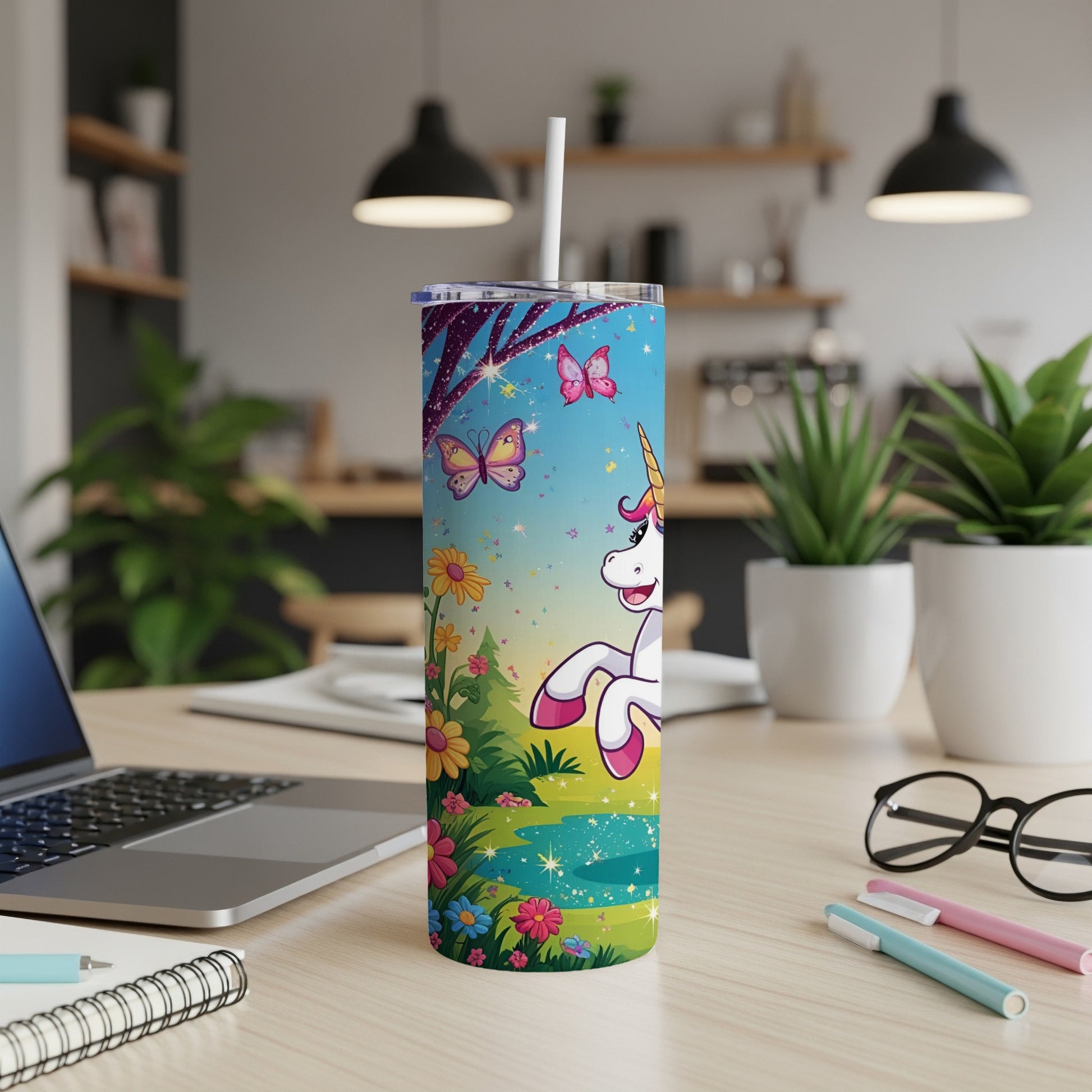 Unicorn and butterflies on a sparkly blue tumbler with a straw.