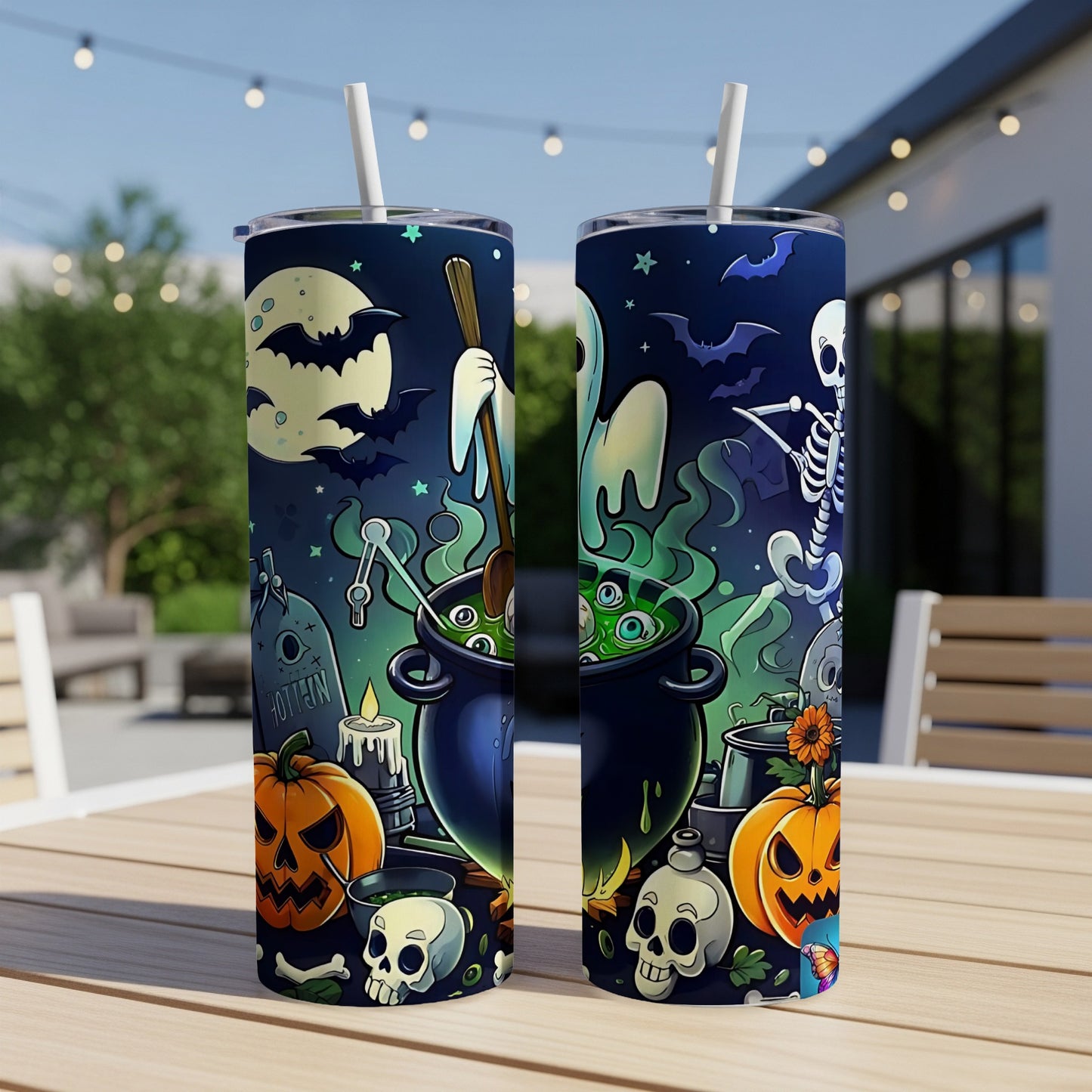 Two tumblers with a Halloween theme featuring a cauldron, ghost, skeleton, bats, pumpkins, and skulls.