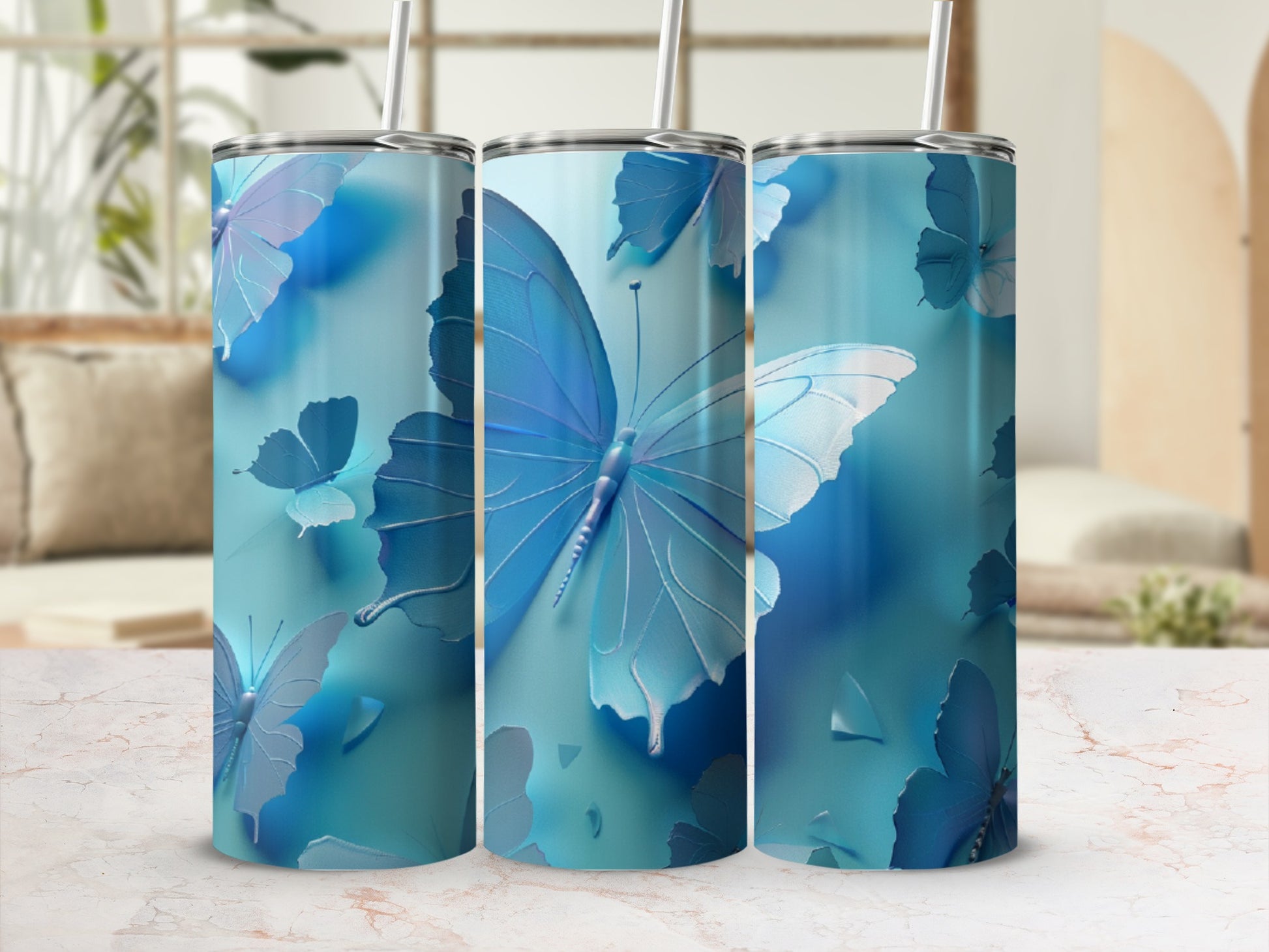 Blue butterfly tumbler with straw in a light, airy setting.