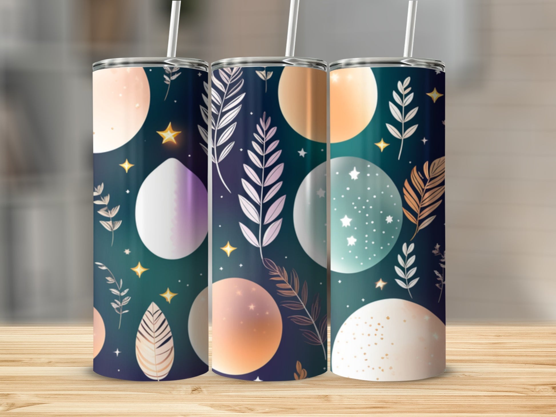 Three tumblers with celestial, starry, and floral patterned designs.