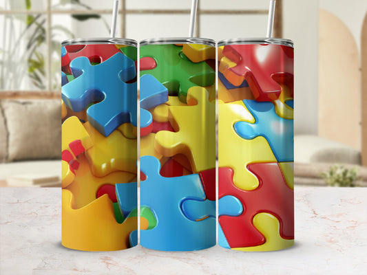 Three stainless steel tumblers with a vibrant, interlocking puzzle piece design.