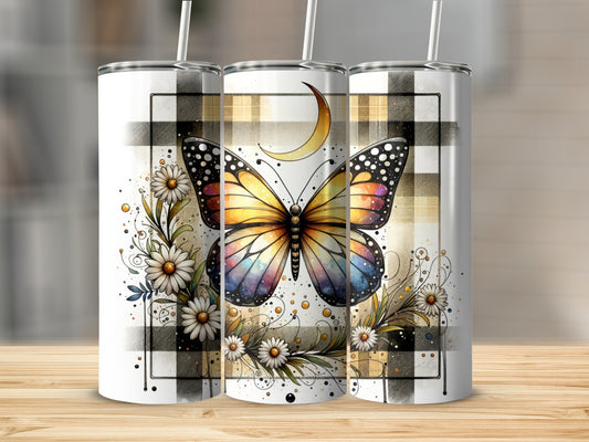 Colorful butterfly and floral design on a plaid patterned tumbler.