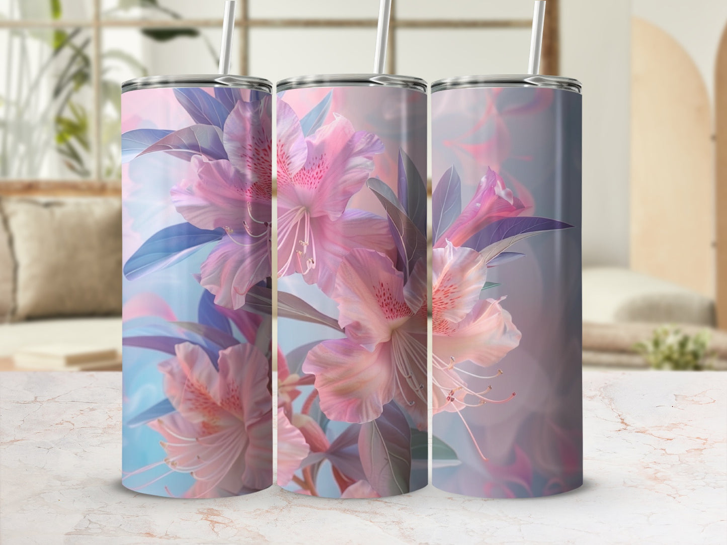 Three tumblers with pink floral design and straw, displayed on a marble surface.