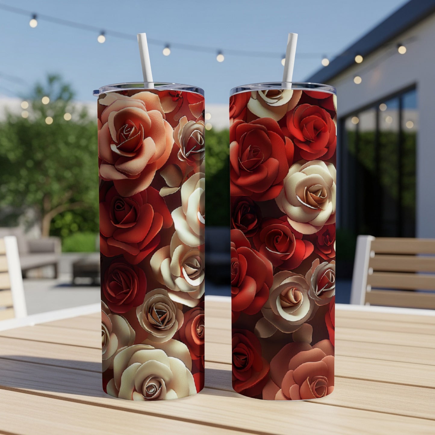 Two tumblers with a red and cream rose floral pattern on a wooden table.