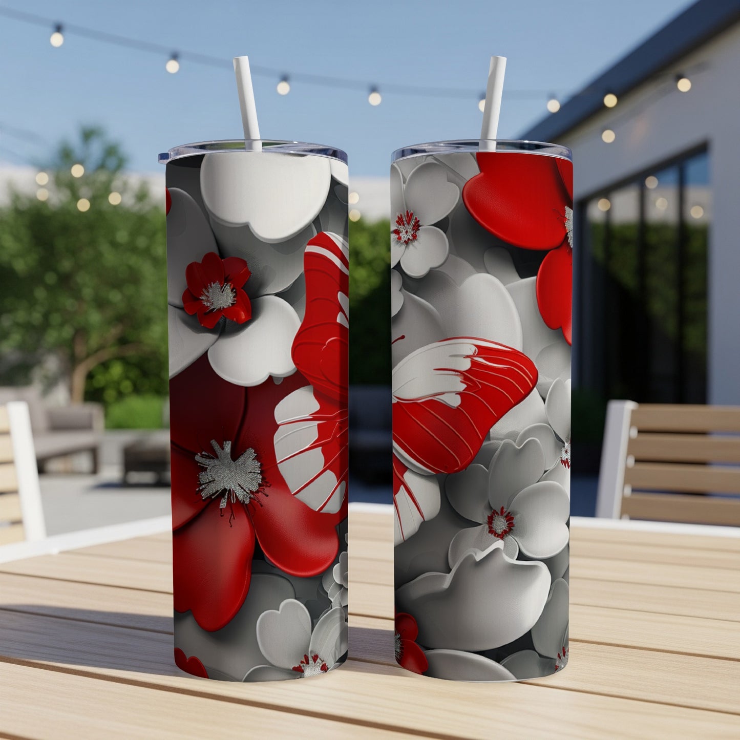 Two tall, skinny tumblers with red butterflies and white flowers.