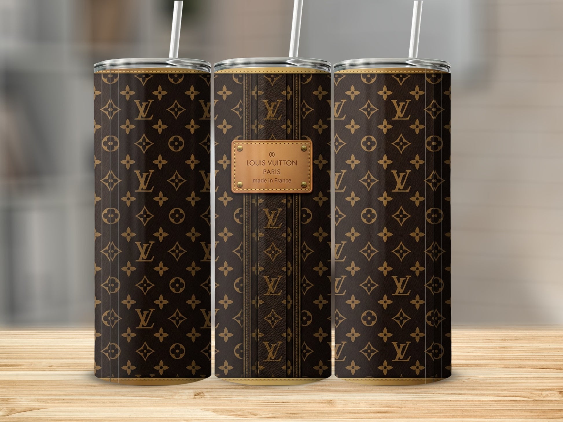 Brown Louis Vuitton pattern tumbler with white straw and Paris label.