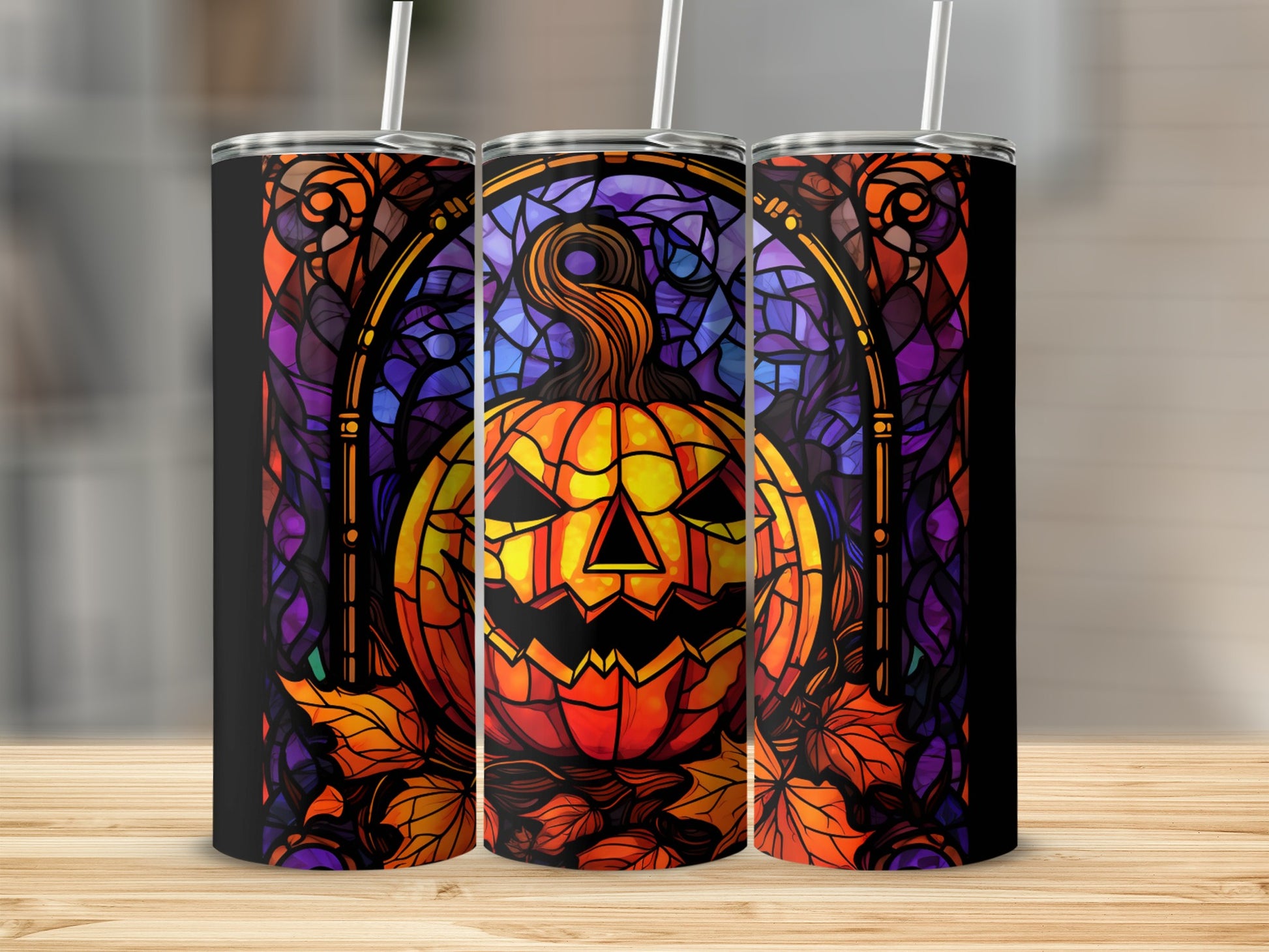 Stained glass pumpkin and autumn leaves pattern on three tumblers.