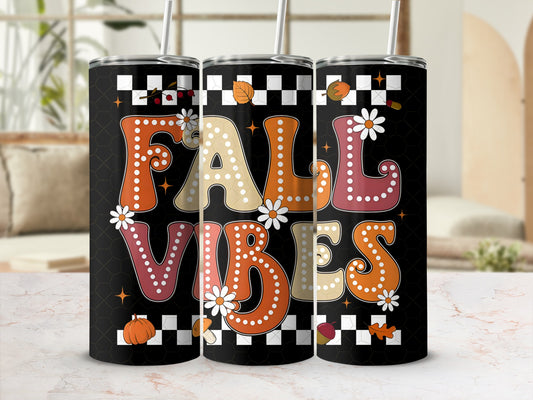 Black tumbler with "FALL VIBES" text, autumn leaves, and pumpkins.