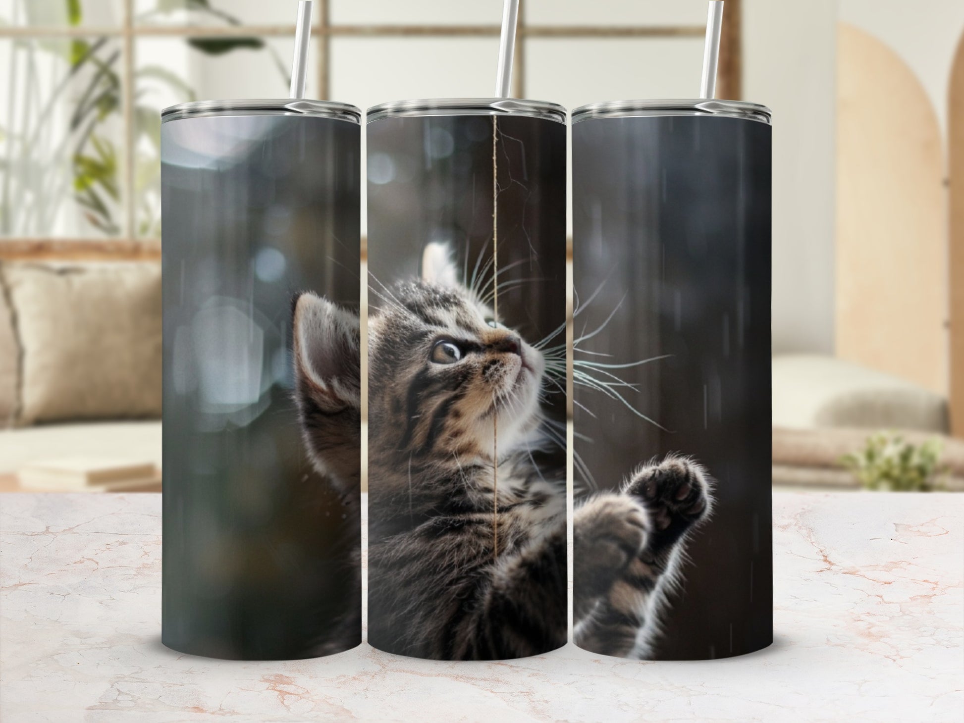 Tabby kitten playing with string, digital art on three tumblers.