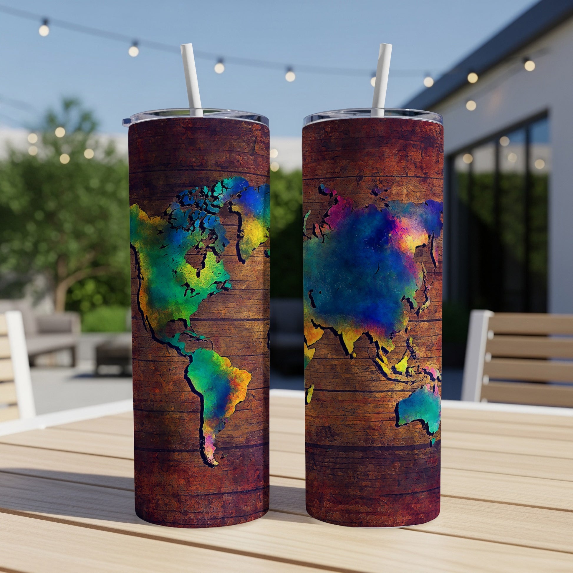 Two tumblers with a colorful world map design on a wood-textured background.