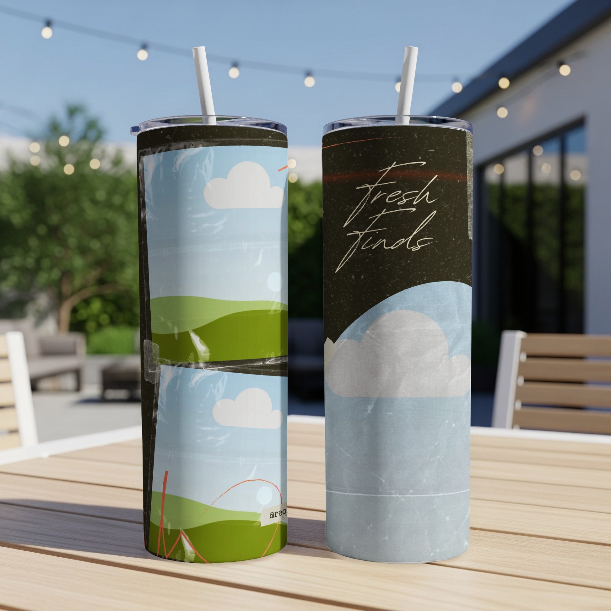 Two tumblers on a table, one with rolling hills and clouds, the other with text.