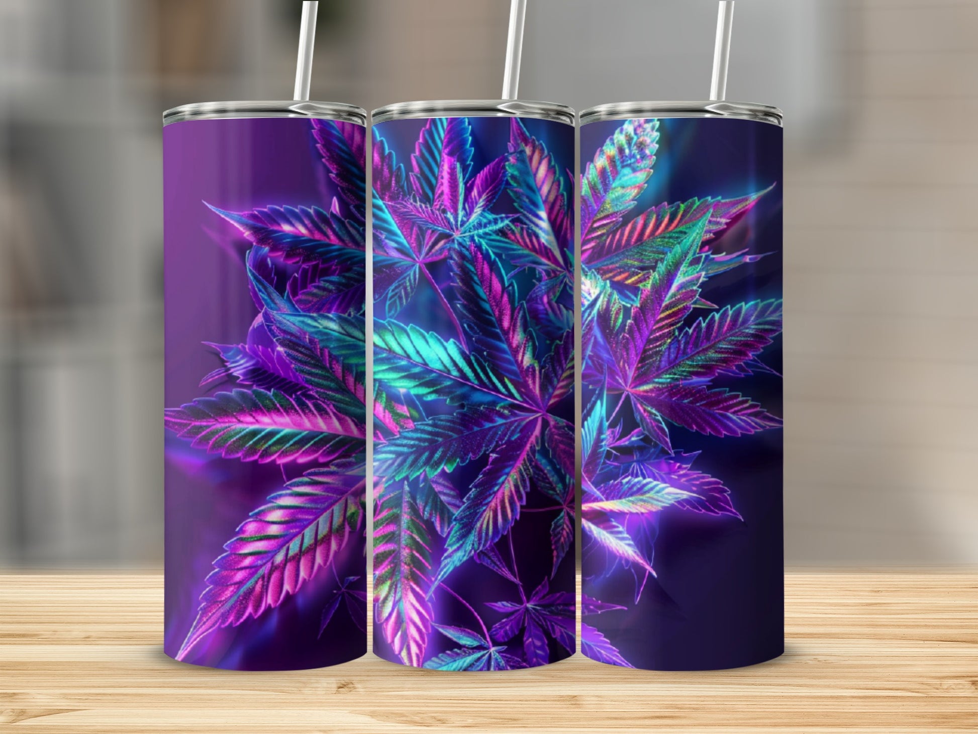 Three tumblers with neon cannabis leaf designs on a wooden surface.