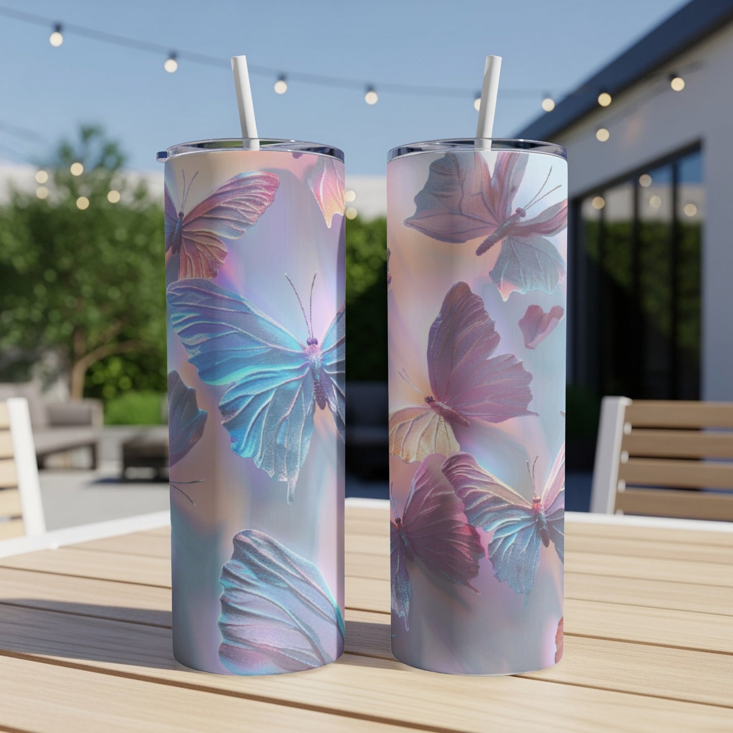Two tumblers with iridescent butterfly designs on an outdoor table.