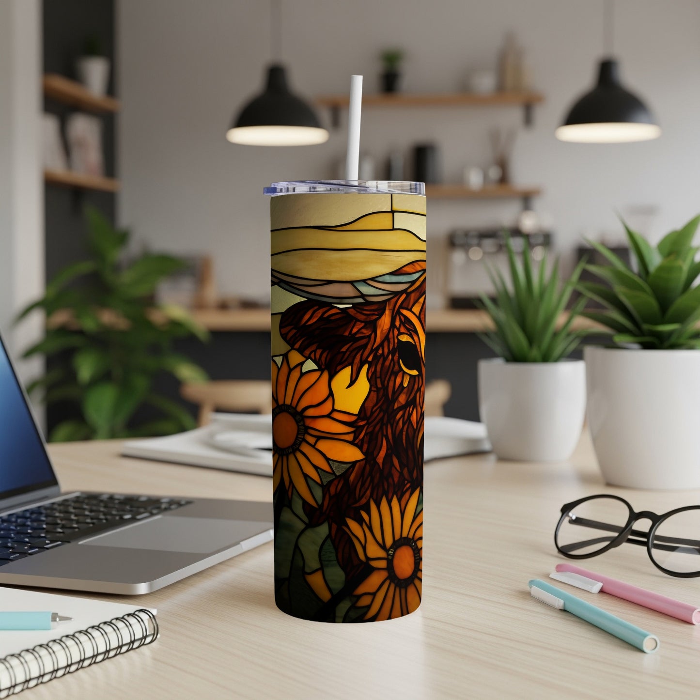 Sunflower and cow design on a white tumbler with a straw.
